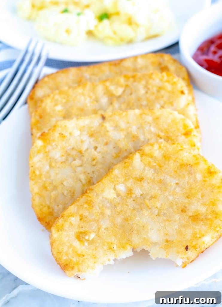 Perfectly Crispy Air Fryer Hash Browns 4 hash browns with a bite taken out