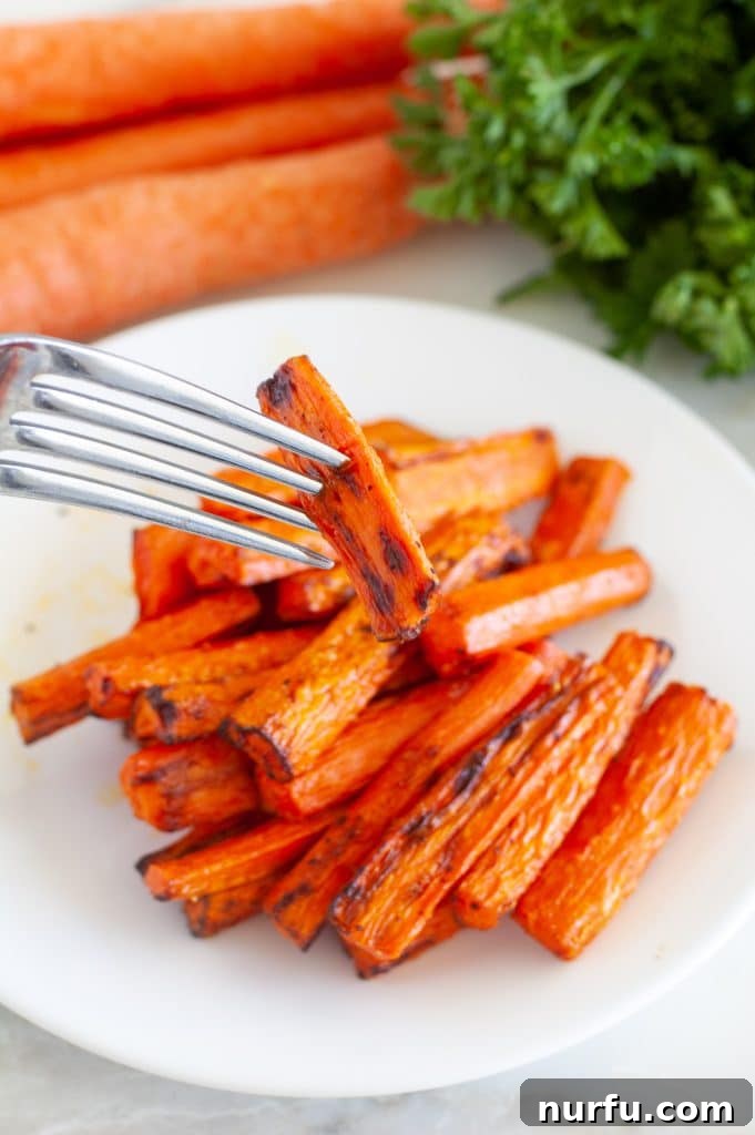 Quick Air Fryer Carrots 4 Roasted carrots with a fork