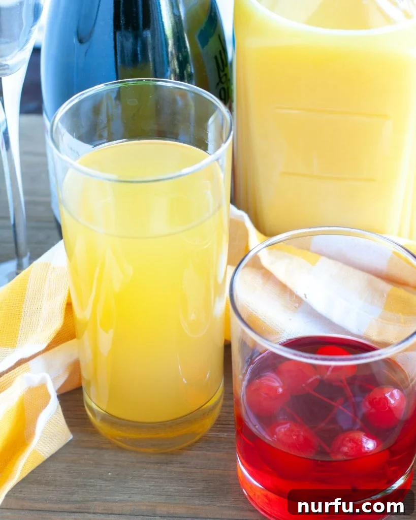 Bottles of pineapple juice, orange juice, maraschino cherries, and sparkling wine, representing the ingredients for Blushing Mimosas.