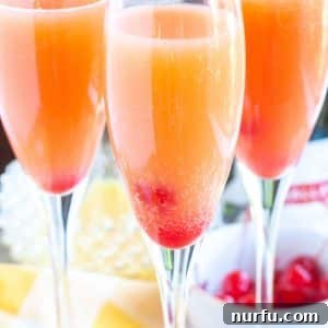 Glass with mimosas and cherries.