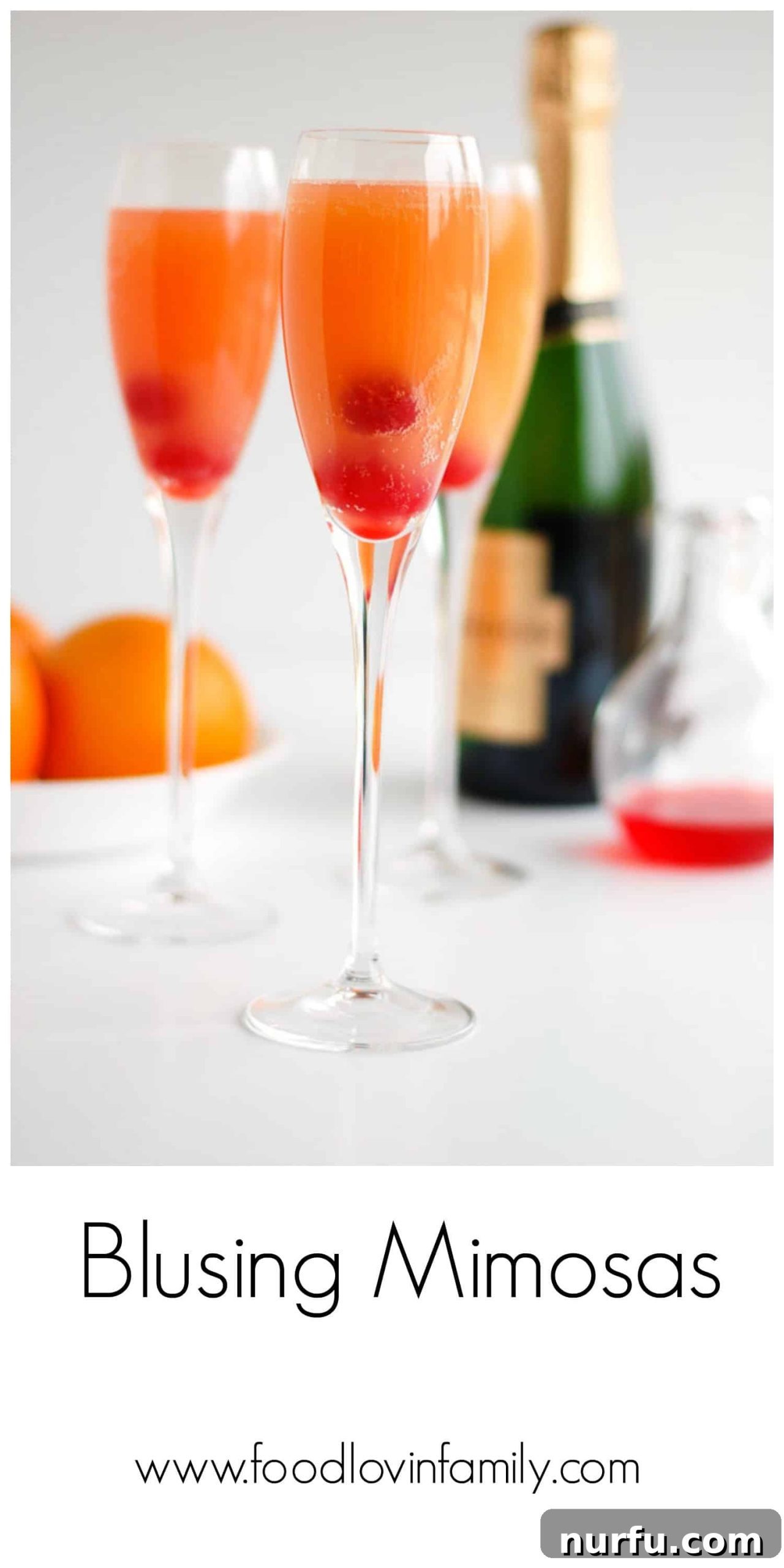 Two tall, elegant glasses of blushing mimosas, garnished with fresh fruit, set against a festive, bright background.