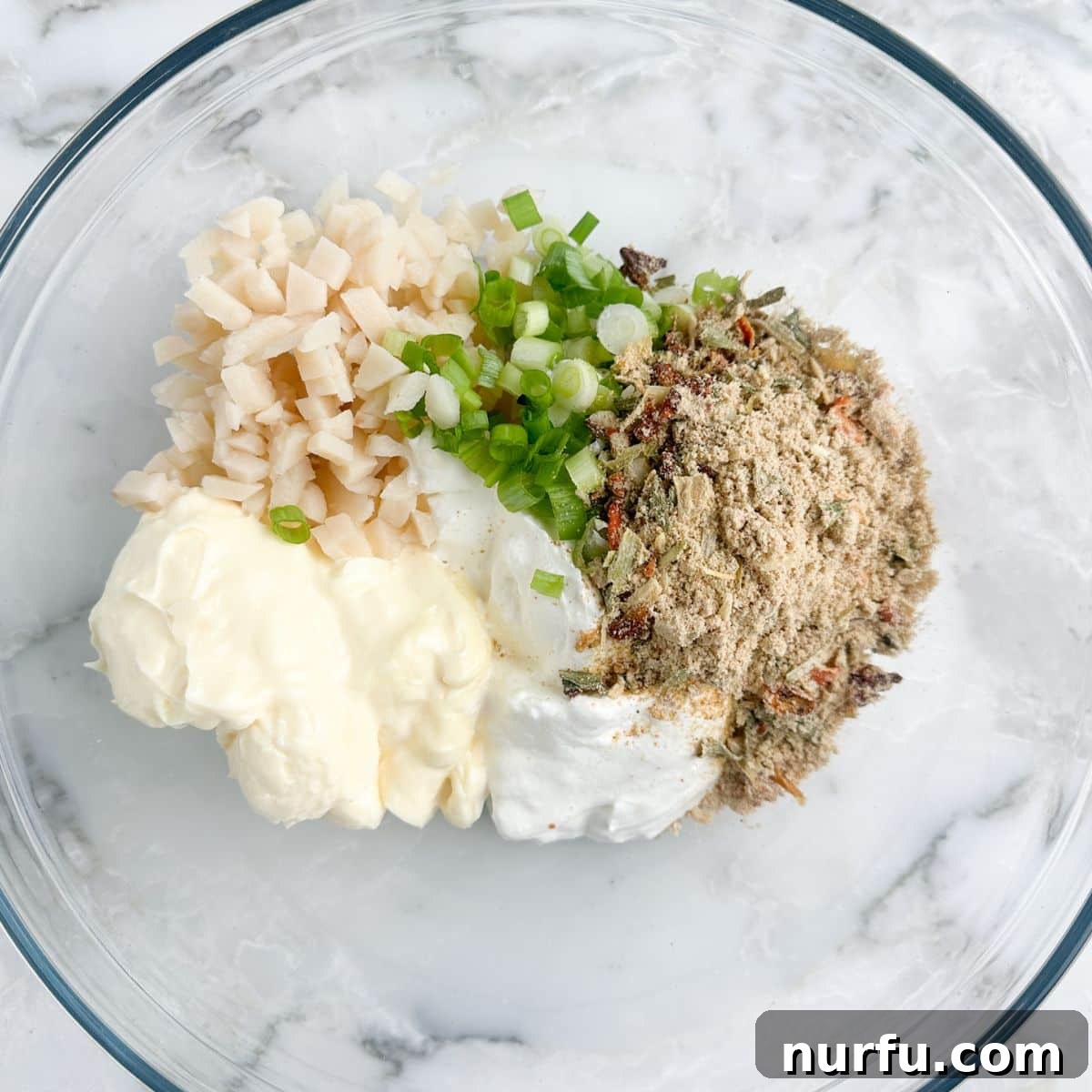 Creamy Knorr Spinach Dip 4 Bowl with mayonnaise, sour cream, water chestnuts, and vegetable mix.