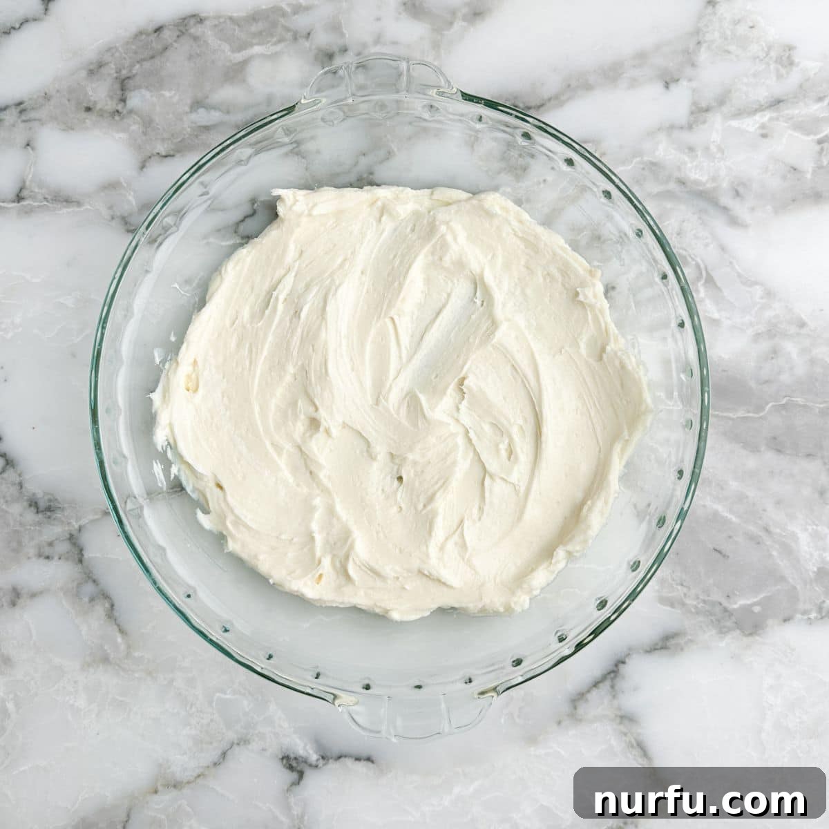 Heavenly Caramel Apple Dip 4 Pie dish with the prepared cream cheese mixture spread evenly.