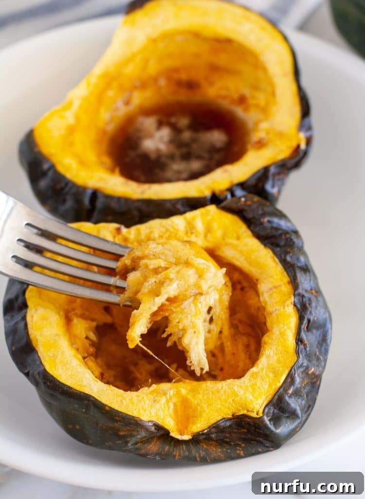 Easy Microwave Acorn Squash 4 A fork scooping tender, seasoned acorn squash from its skin