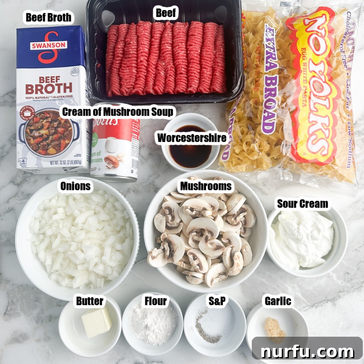 Homemade Skillet Stroganoff with Noodles 3 Ingredients laid out for ground beef stroganoff: ground beef, beef broth, onion, mushrooms, flour, sour cream, and garlic.
