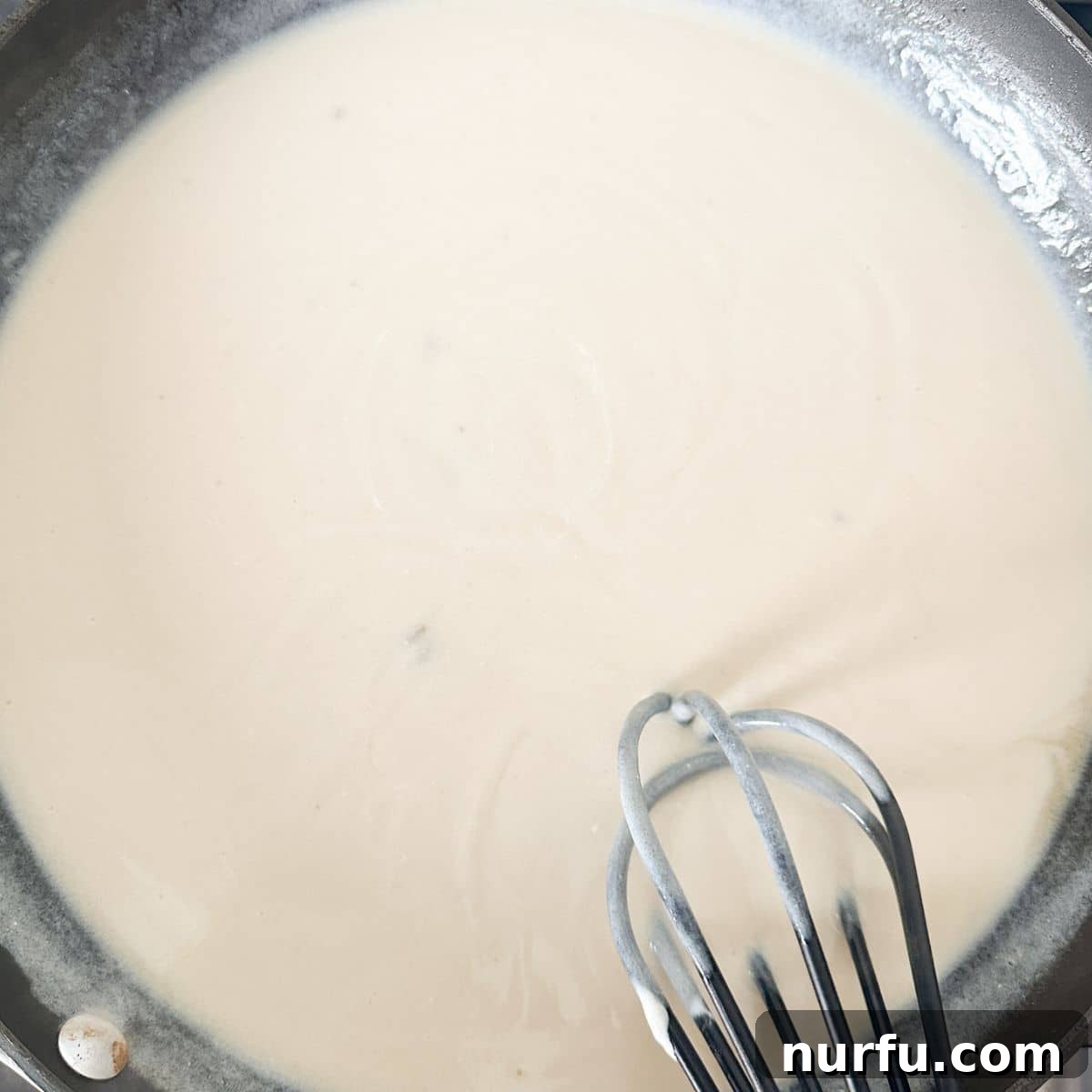 Homemade Skillet Stroganoff with Noodles 5 A creamy, thickening sauce in a skillet, ready for the beef mixture.