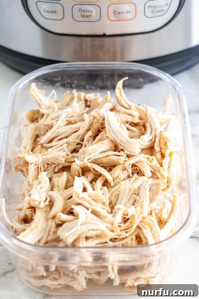 Speedy Instant Pot Pulled Chicken 2 Delicious shredded chicken ready for meal prep, stored in a clear container