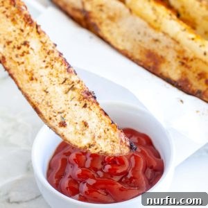 potato wedge dipped in ketchup