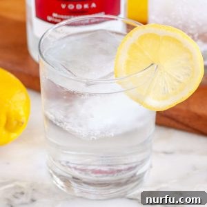 Glass with water and lemon slice.