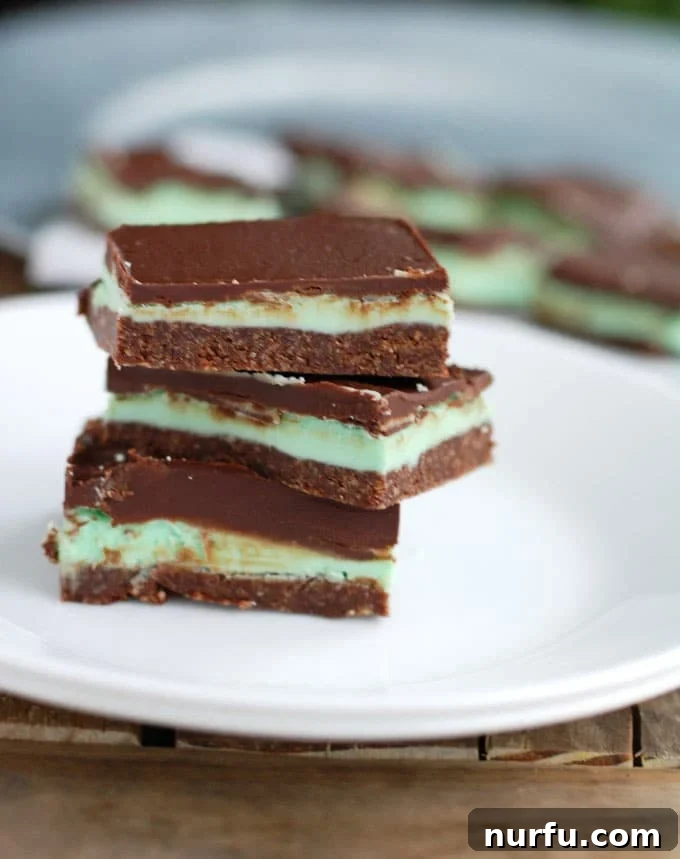 Multiple creme de menthe bars arranged artfully on a serving dish.