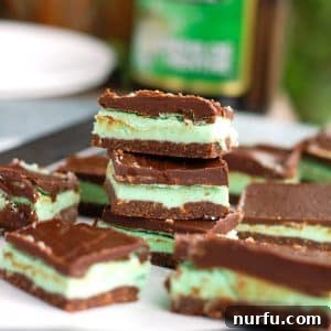 Creme De Menthe Bars stacked on plate.