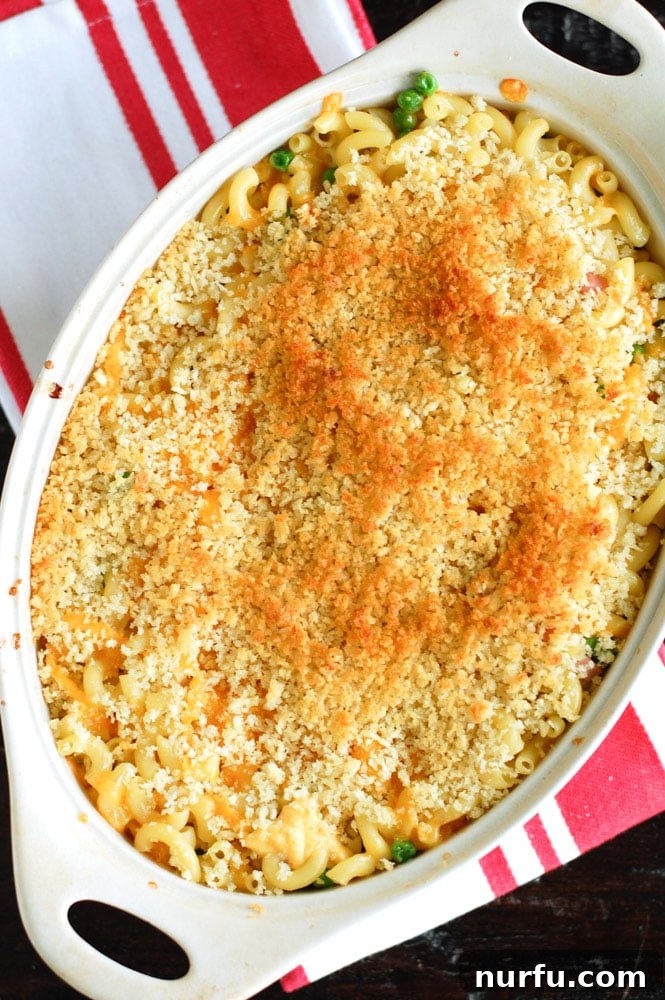 Creamy Macaroni and Cheese with Ham and Peas, ready for the oven Preparing the Macaroni and Cheese with Ham and Peas for baking