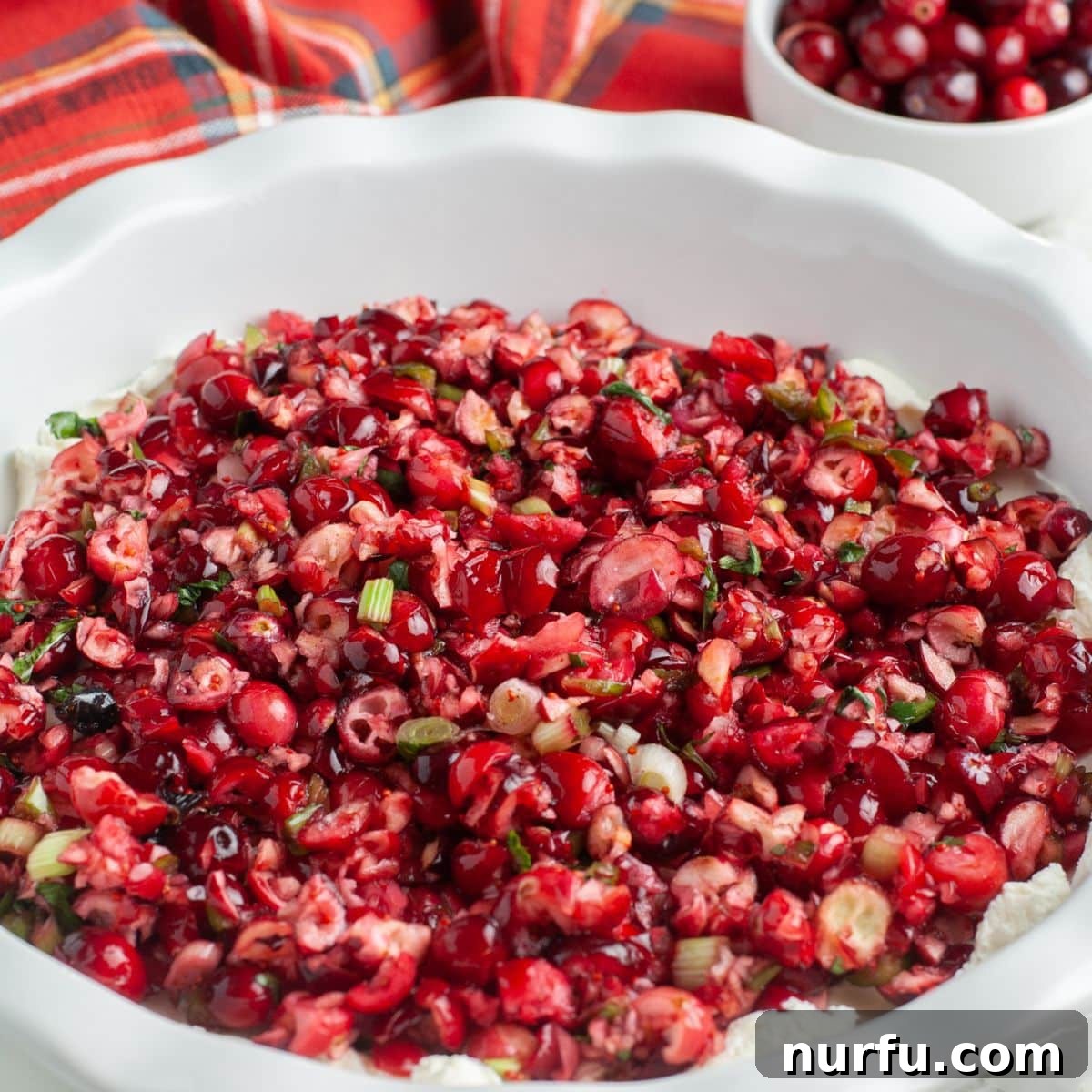 Festive pie dish with cranberry cream cheese dip, ready for holiday entertaining.