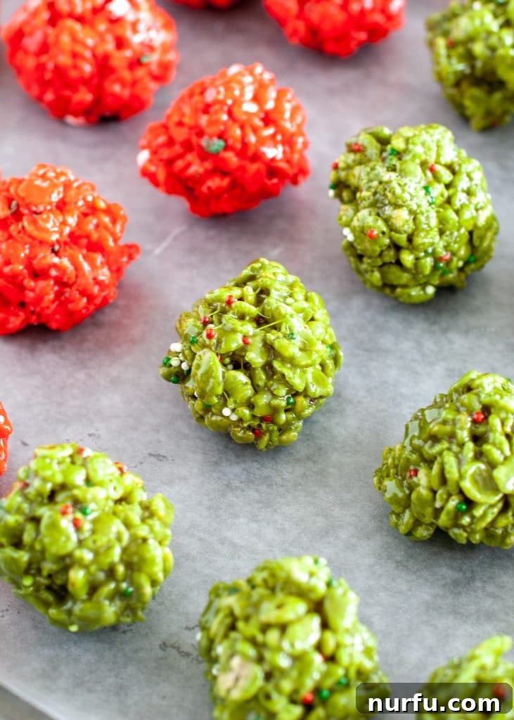 Festive Crispy Delights 5 Red and green Christmas Rice Krispie treat bites scattered on a baking sheet, ready to set.