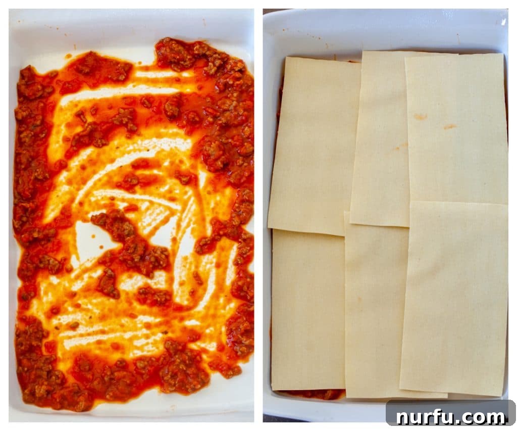 A 9x13 inch casserole dish with a generous layer of rich marinara meat sauce, topped with a perfectly laid layer of no-boil lasagna noodles, ready for the next delicious filling.