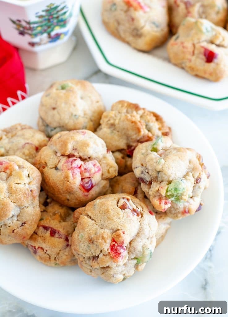 A charming stack of festive Christmas fruitcake cookies, beautifully arranged on a plate, ready to be enjoyed.