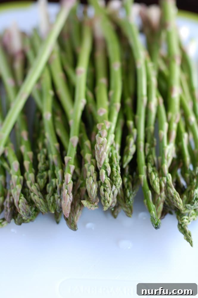 Close-up of roasted asparagus with soy and honey, showing the caramelized texture and sesame seeds.