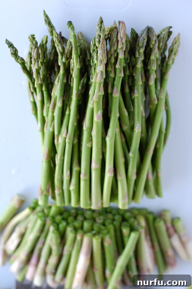 Roasted asparagus served in a pan, ready to be eaten, highlighting the golden glaze.