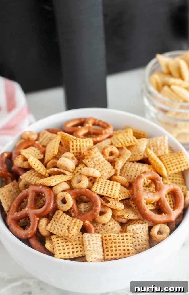 Air Fried Chex Mix Perfection 2 A vibrant bowl of homemade Air Fryer Chex Mix, featuring a delightful blend of crispy cereals and pretzels, perfectly seasoned and ready to enjoy.