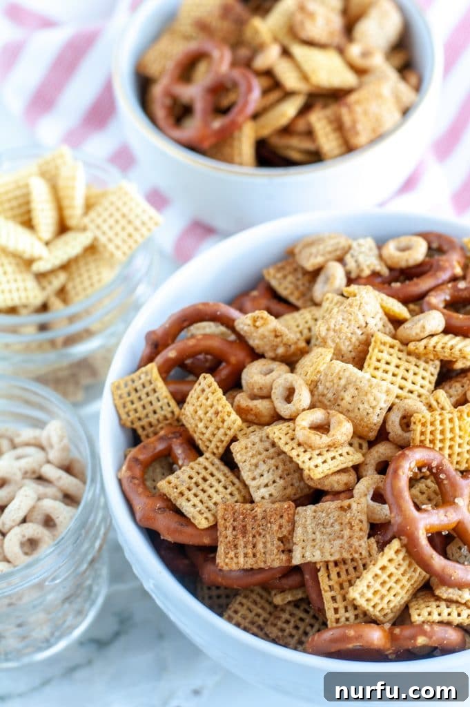 Air Fried Chex Mix Perfection 5 A beautifully presented bowl of air-fried snack mix, accompanied by separate bowls of Chex cereal, emphasizing the homemade goodness.