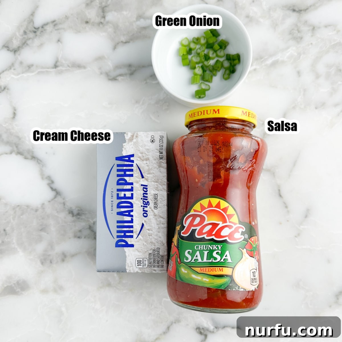 Ultimate Cream Cheese Salsa Dip 3 The essential ingredients laid out: a jar of robust salsa, a block of softened cream cheese, and a small pile of freshly diced green onions, showcasing the simplicity of this dip.