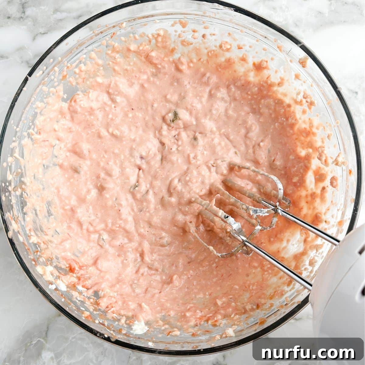 Ultimate Cream Cheese Salsa Dip 5 The electric mixer actively blending the cream cheese and salsa into a smooth, homogenous dip, showcasing the mixing process.