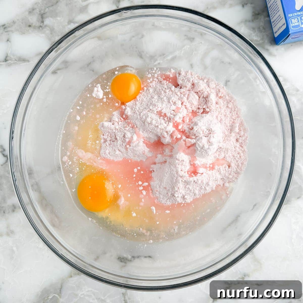 Effortless Strawberry Cake Mix Squares 4 Bowl of cake mix, eggs, and oil.