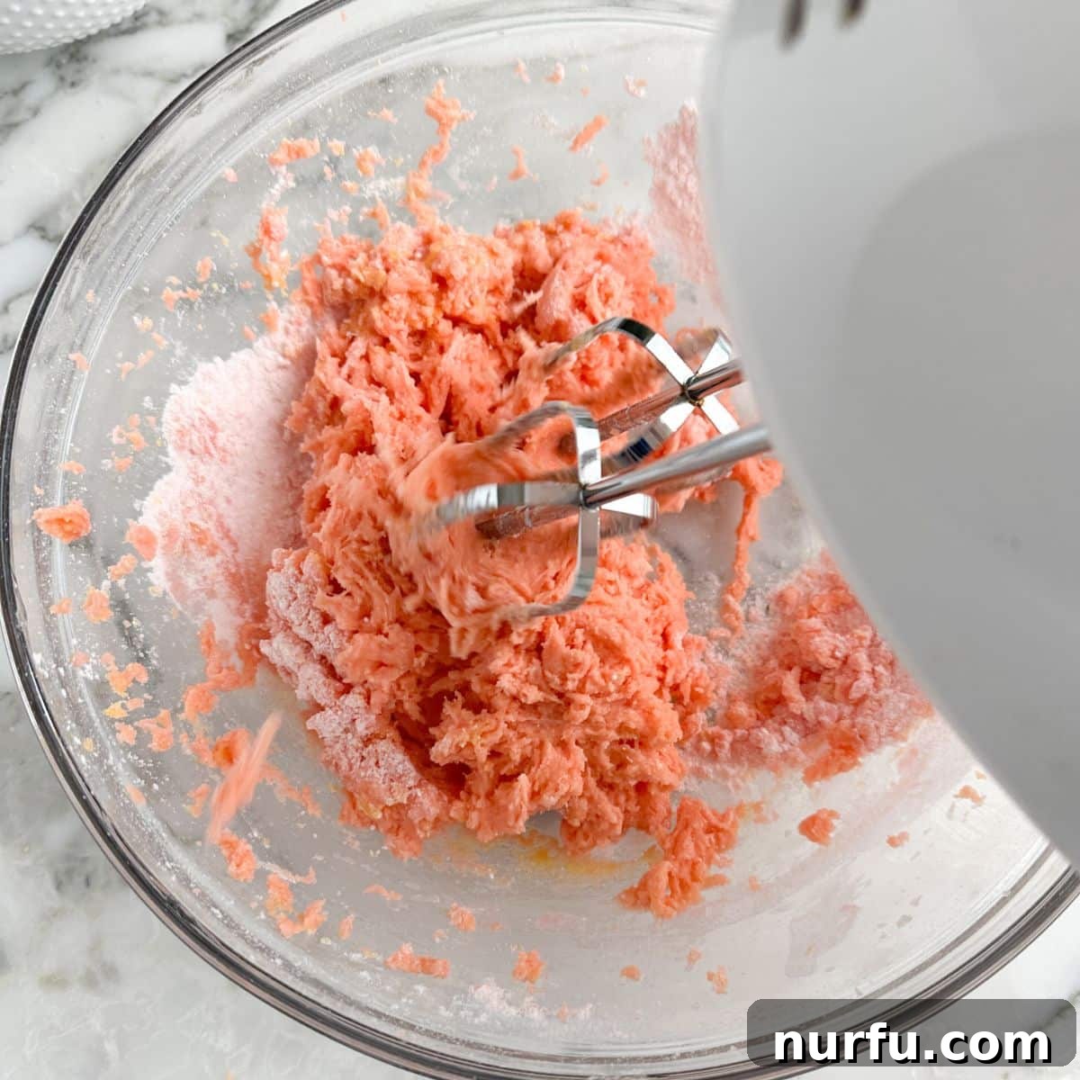 Effortless Strawberry Cake Mix Squares 5 Bowl with strawberry bars batter and a mixer.