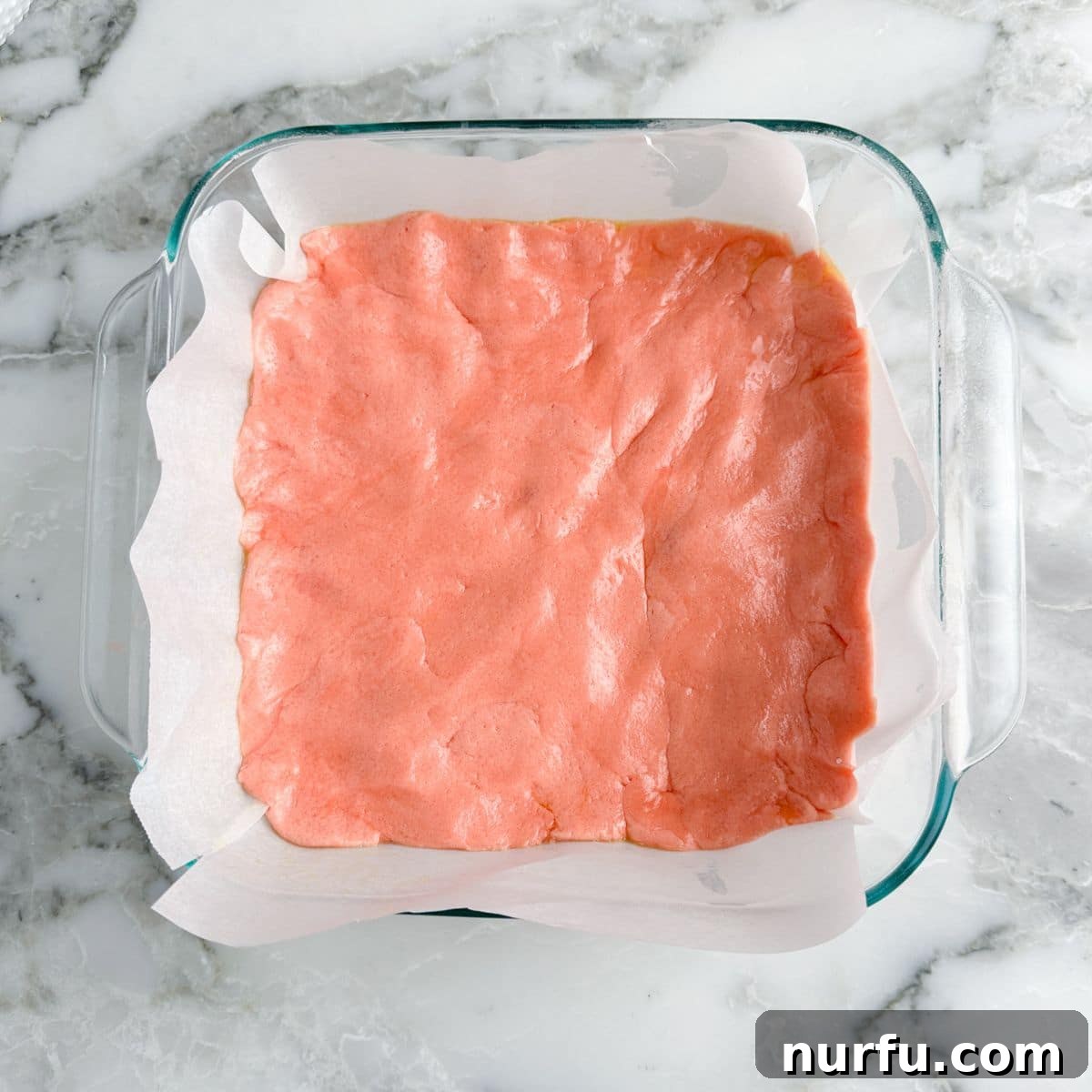 Effortless Strawberry Cake Mix Squares 6 Baking dish with strawberry bar batter.