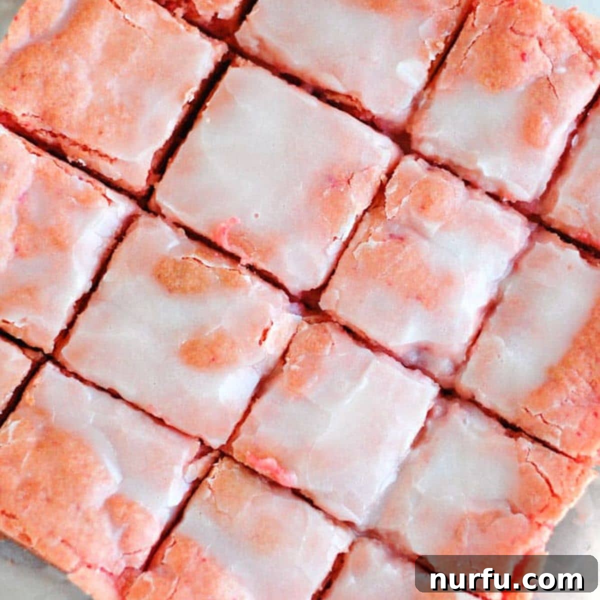 Strawberry cake bars cut into squares Sliced strawberry bars.