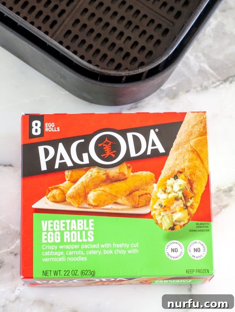 Air Fryer Crispy Egg Rolls: From Freezer to Fantastic 3 A box of frozen egg rolls and air fryer basket.