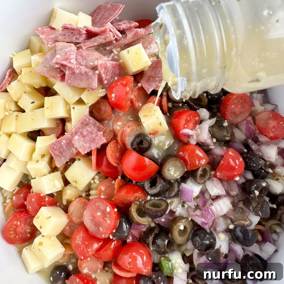 Zesty Pepperoni Pasta Medley 5 Bowl with diced cheese, salami, olives, tomatoes, and dressing.