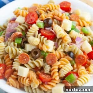 Zesty Pepperoni Pasta Medley 7 Bowl of pasta salad with pepperoni, tomatoes, and cheese.