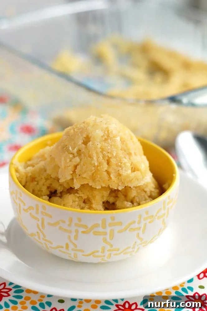Chi-Chi's Sweet Corn Cake A golden-yellow Chi-Chi's Sweet Corn Cake in a vibrant yellow and white patterned bowl, ready to be served as a delicious side dish.