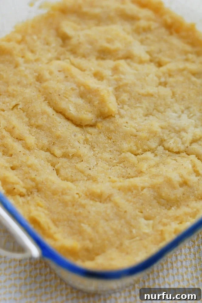 Chi-Chi's Sweet Corn Cake A freshly baked Copycat Chi-Chi's Sweet Corn Cake, golden brown and moist, resting in a glass baking dish, ready to be portioned.