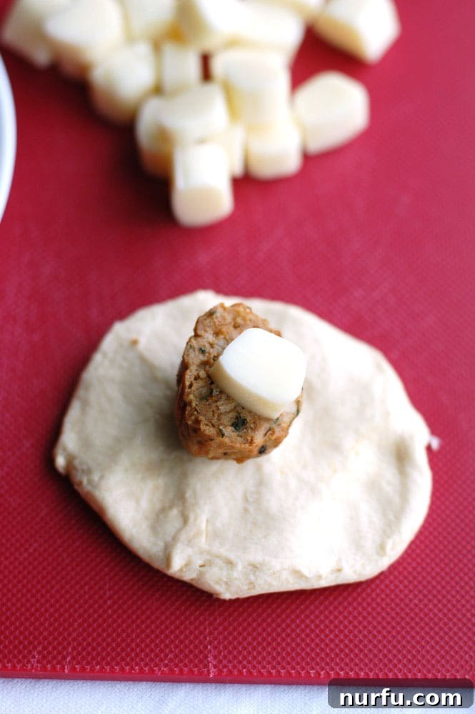 Meatball biscuit bombs Several meatball biscuit bombs arranged in a round baking pan, drizzled with butter and ready for the oven.