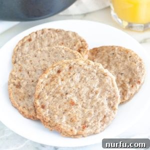 Plate with cooked breakfast sausage patties.