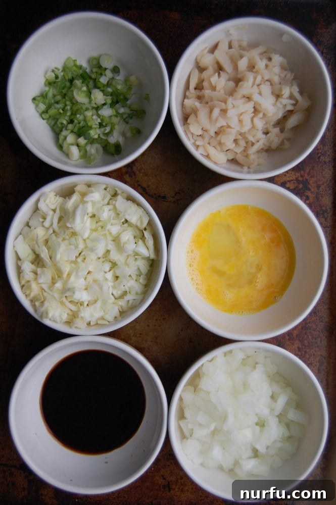 Crispy Vietnamese Spring Rolls with Tropical Pineapple Dip 3 A bowl filled with finely diced fresh ingredients for Lumpia filling, including green onions, onions, cabbage, and water chestnuts, ready to be mixed with meat.