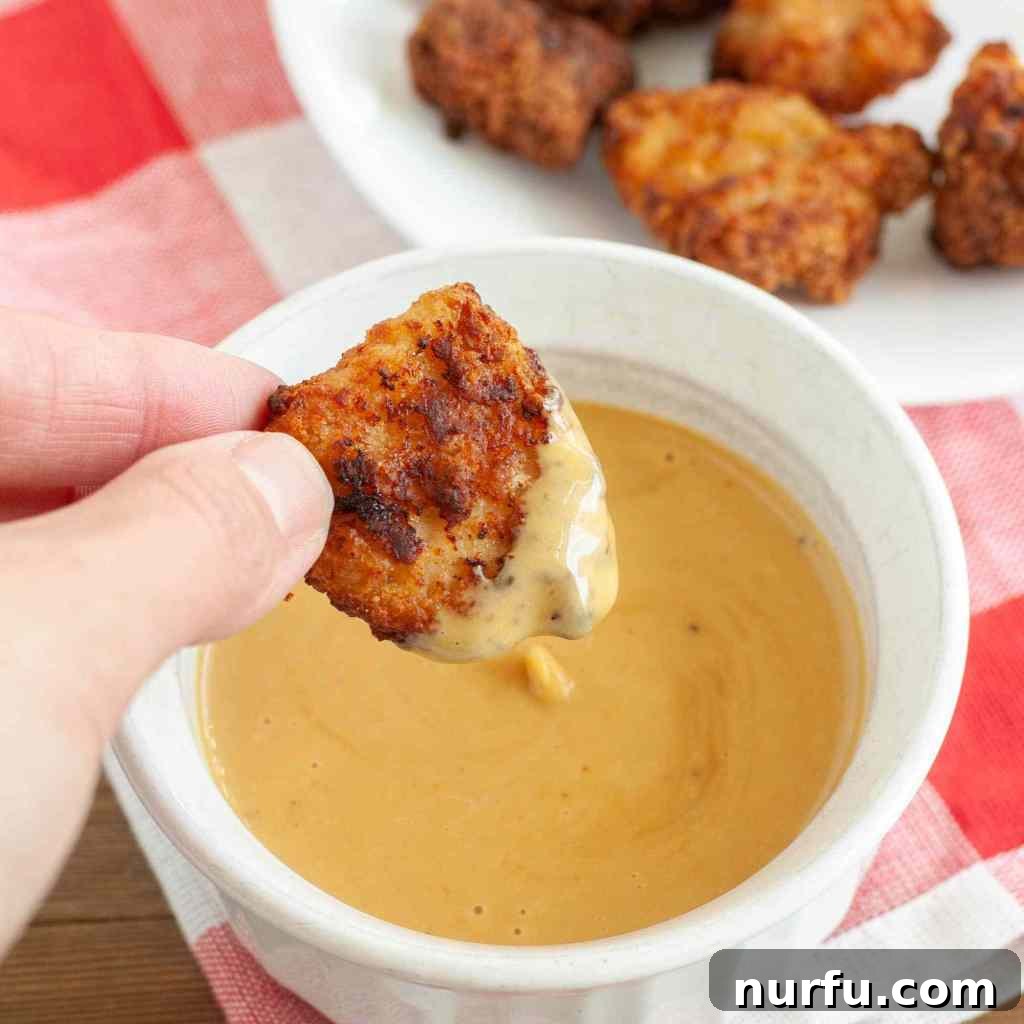 Discover N-Foods 6 Chicken nugget dipped in sauce.