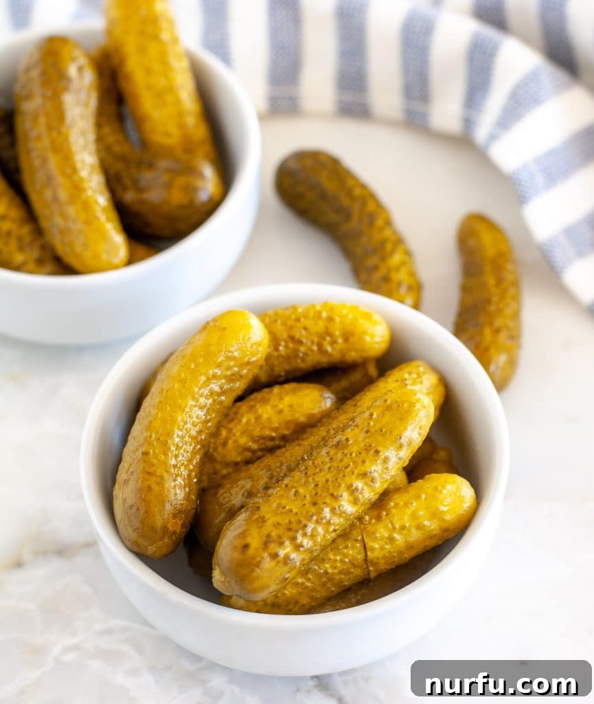40 Glorious G-Foods 6 Two rustic bowls filled with small, tangy gherkin pickles, ready to be enjoyed as a snack or side dish.