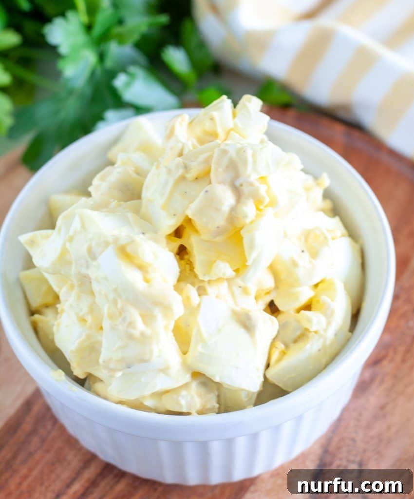 A beautifully presented bowl of creamy egg salad, ready to be served.