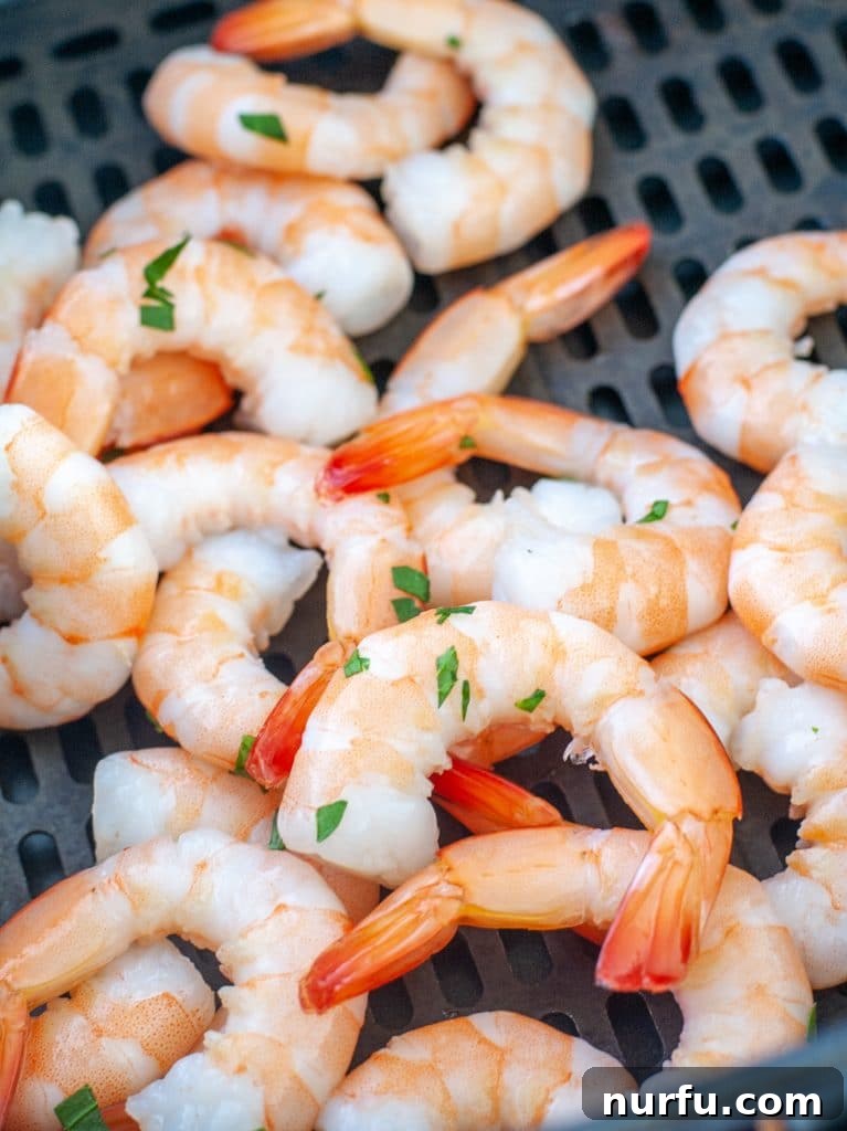 Shrimp in air fryer basket. 