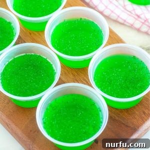 Board with cups of green jello.