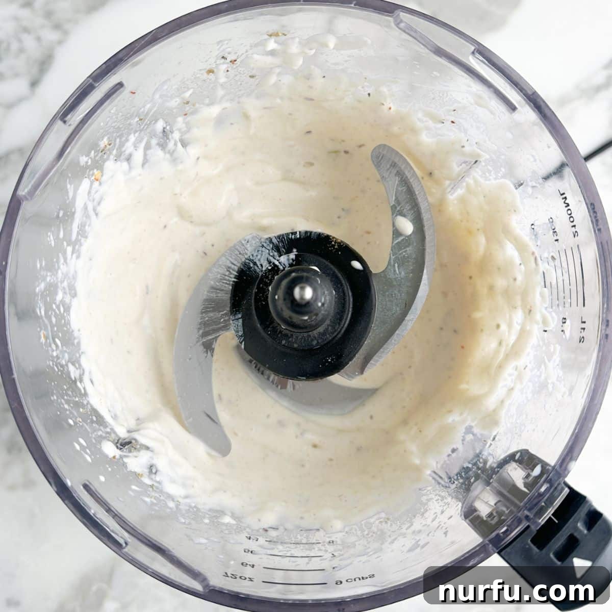 Creamy Mexican Restaurant White Sauce 5 A food processor bowl filled with creamy white sauce, blended and ready for chilling.