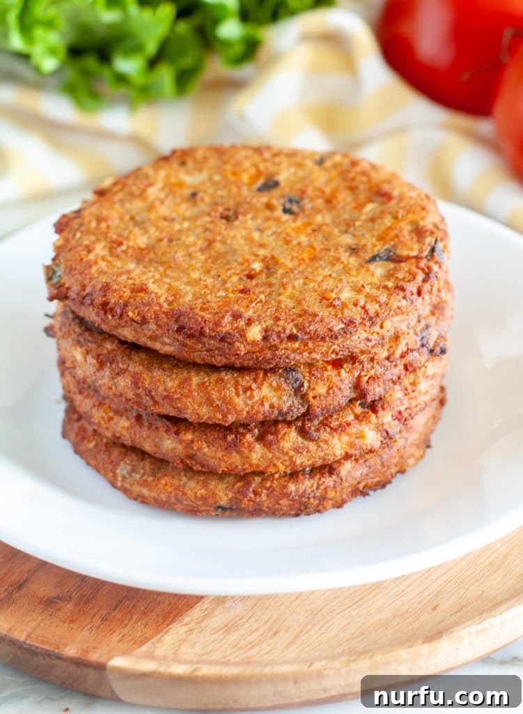 Crispy Air Fryer Frozen Veggie Burgers 4 A stack of perfectly air-fried veggie burgers on a plate.