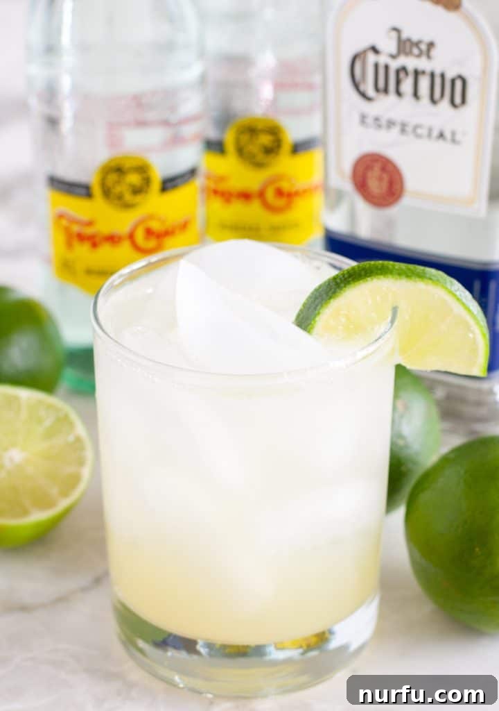 A tall glass filled with ice and Ranch Water, garnished with a vibrant lime slice, signifying ultimate refreshment.