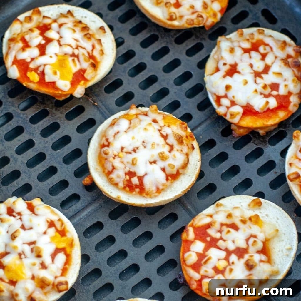 Unlock Perfect Air Fryer Bagel Bites 2 Bagel bites in air fryer basket, ready to cook.