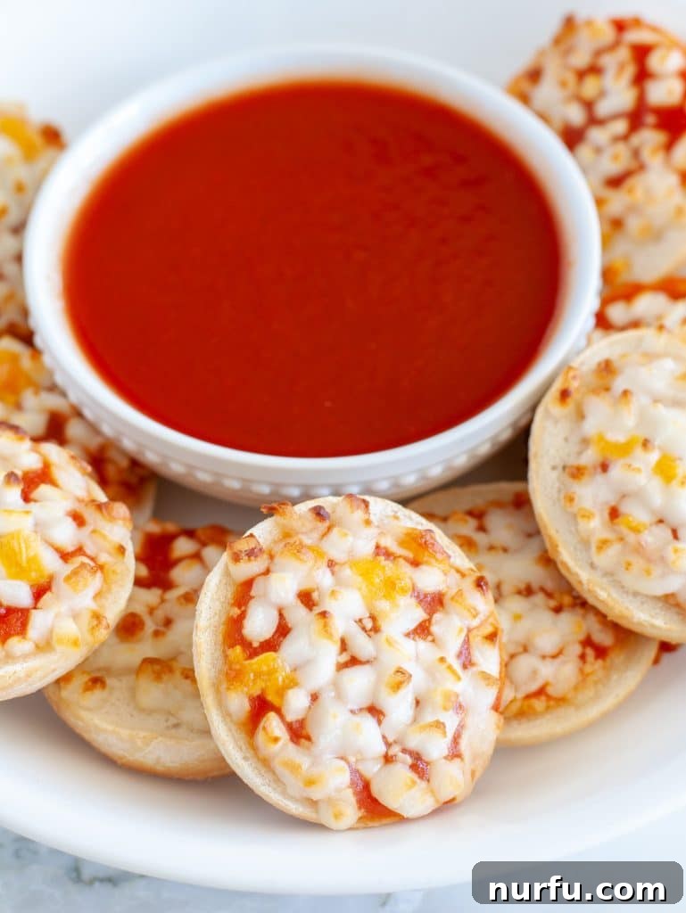 Unlock Perfect Air Fryer Bagel Bites 4 Plate of crispy bagel bites with a side of marinara sauce.
