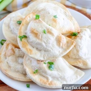 Plate full of pierogies, golden and ready to eat.