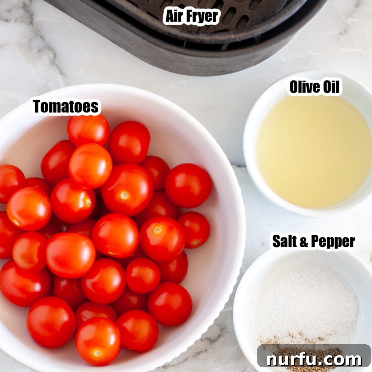 Air Fried Tomato Bites 3 A vibrant bowl of cherry tomatoes alongside a bottle of olive oil, salt, and pepper, ready for air frying.